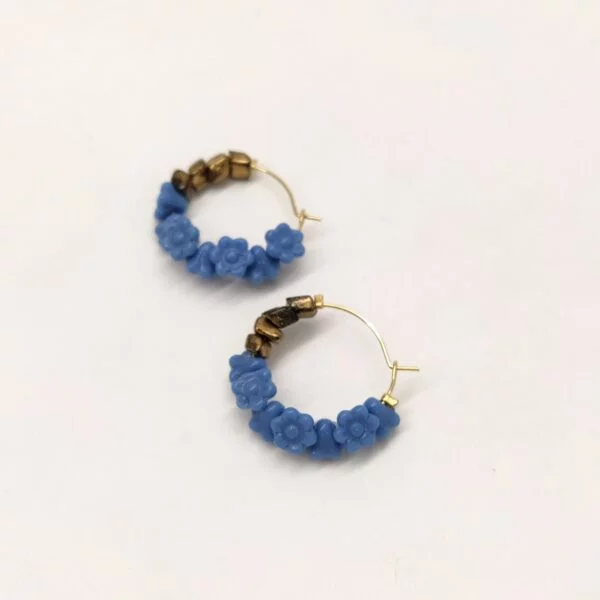 Créoles en laiton doré à l'or fin de diamètre 2cm composées de perles de verre bleu pervenche en forme de fleurs des années 1980 et de perles de verre bronze des années 1960.