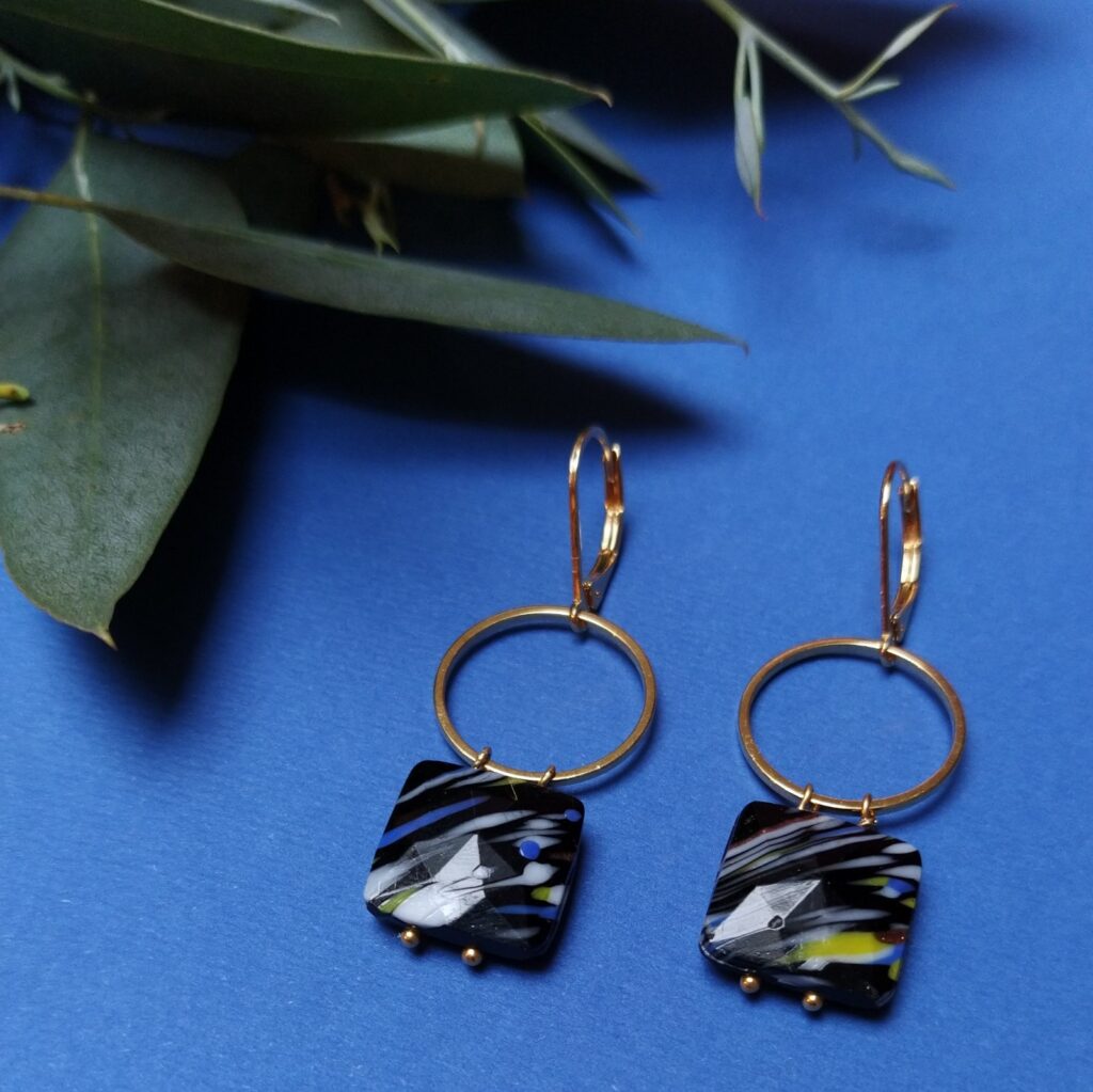 Dormeuses en laiton doré à l'or fin composées de perles de verre carrées destinées à la passementerie montées sur un cercle de laiton également doré à l'or fin.